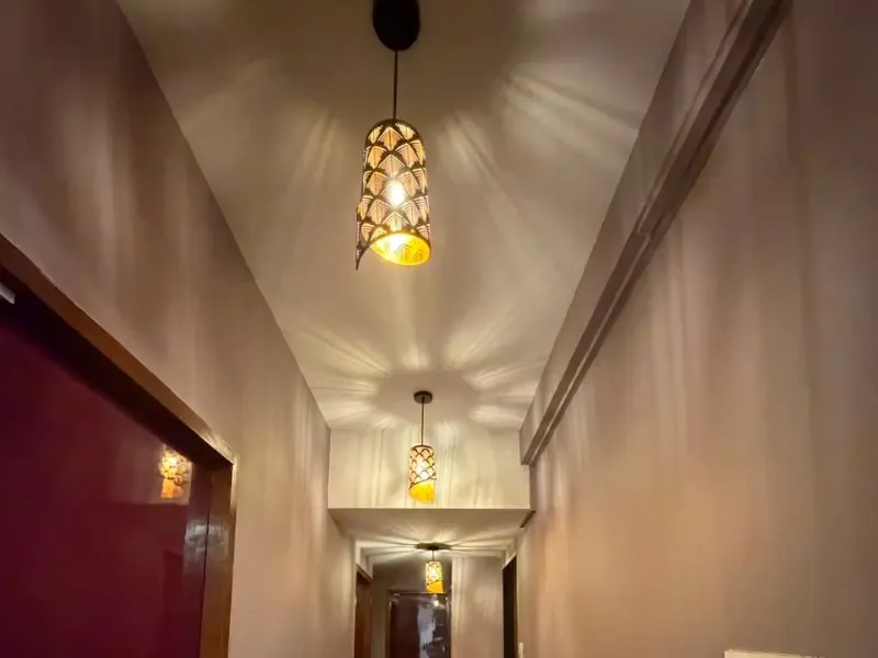 Corridor leading to the massage rooms at ILA Spa, with pendant lamps