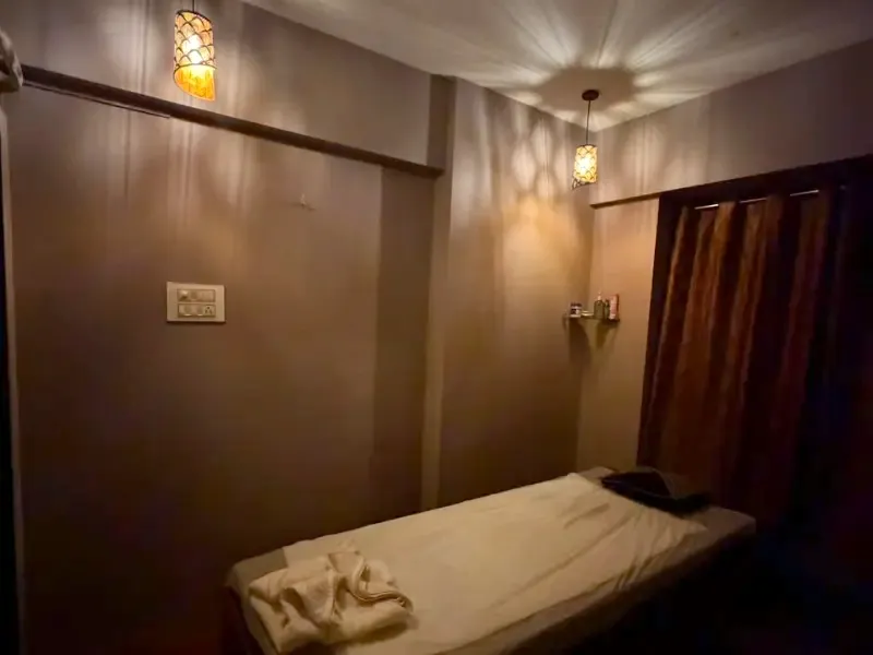 Massage room at ILA Spa in Borivali West, lit by patterned pendant lamps
