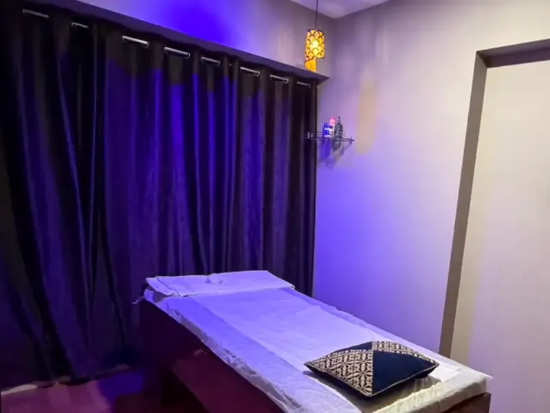 Massage room at ILA Spa with curtains and soft blue lighting